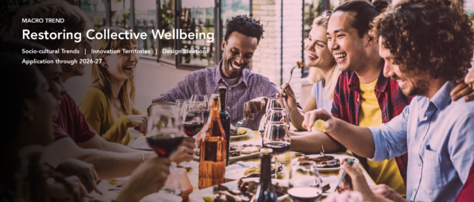 Title page of the January 2025 trend report, Restoring Collective Wellbeing. The image shows a group of 30-something adults sharing a meal around a table