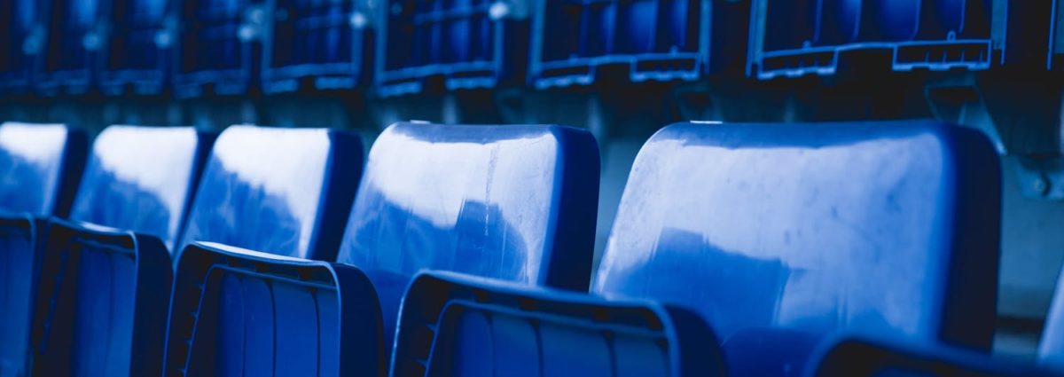 Blue stadium chairs folded up.