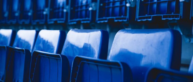 Blue stadium chairs folded up.