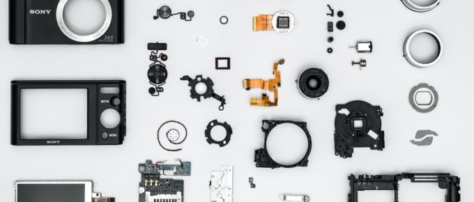 Design for disassembly - Camera taken apart and spread on table.