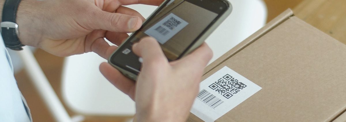 Holding a phone and scanning the QR code on smart packaging