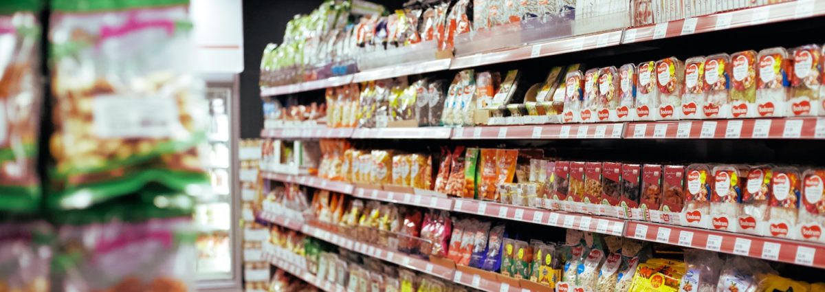 Grocery store shelves full of packaged goods.