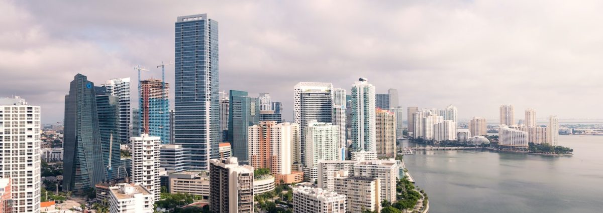 An aerial view of downtown Miami showing waterfront walking paths, parks and pools.