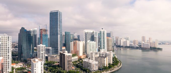 An aerial view of downtown Miami showing waterfront walking paths, parks and pools.