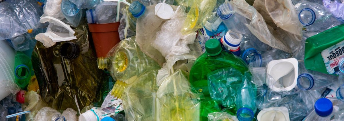 Close up of plastic bottles in a large container for collection and recycling.